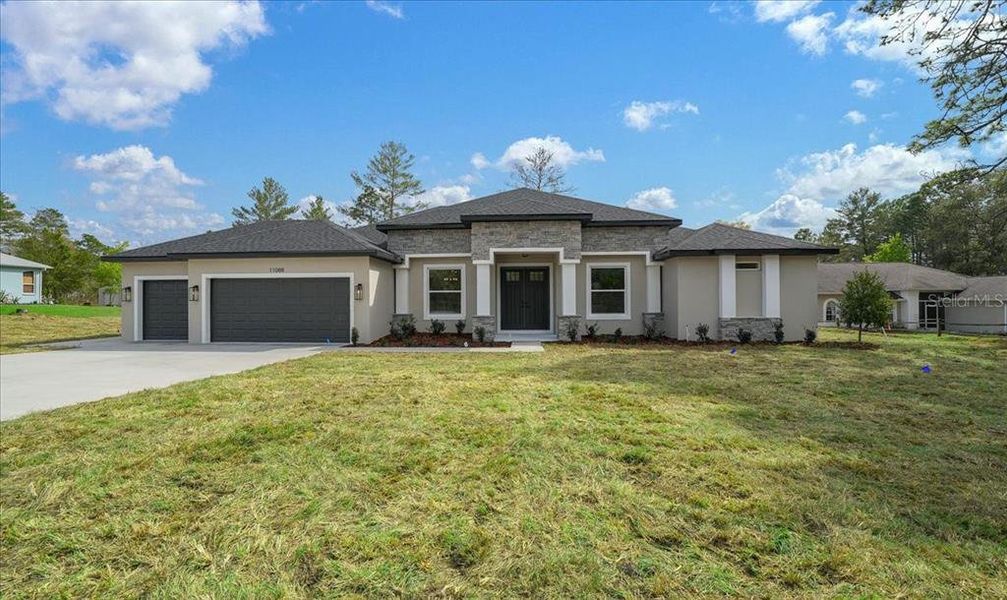 Front exterior of a new home in , Weeki Wachee, FL, highlighting curb appeal (Image 33).