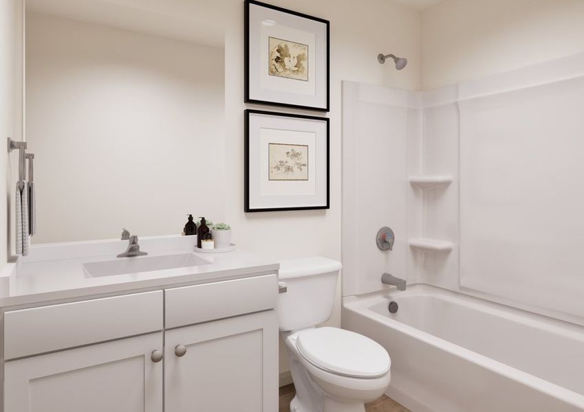 Modern bathroom featuring a white vanity, toilet, shower-tub combo, and framed artwork on the wall. Modern bathroom featuring a white vanity, toilet, shower-tub combo, and framed artwork on the wall.