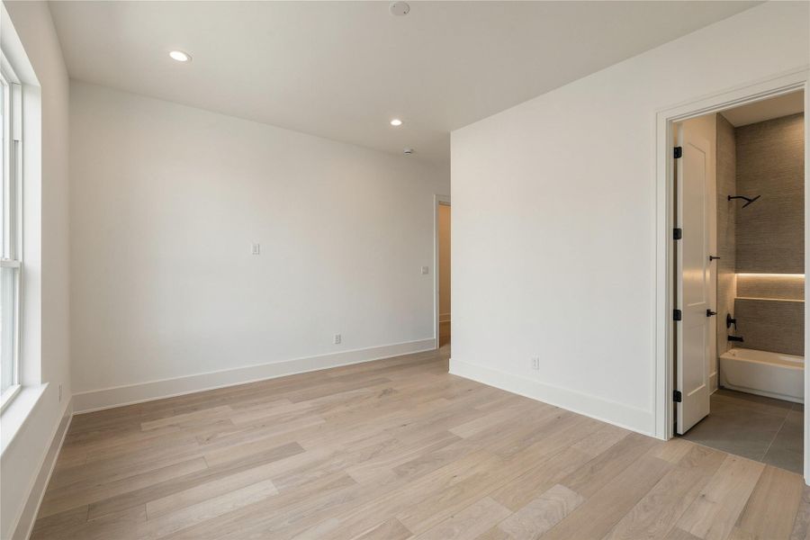 A second perspective reveals the bedroom’s walk-in closet and generous floor space, allowing for multiple furniture configurations without compromising the room’s openness.