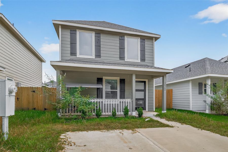 Front exterior of a new home in Marie Village, Conroe, TX, highlighting curb appeal (Image 18). Front exterior of a new home in Marie Village, Conroe, TX, highlighting curb appeal (Image 18).