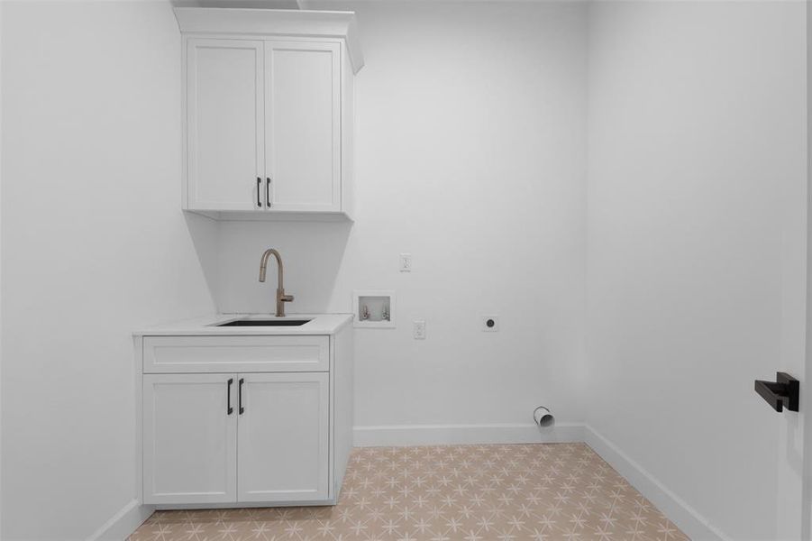 Laundry area featuring washer hookup, electric dryer hookup, and cabinet space