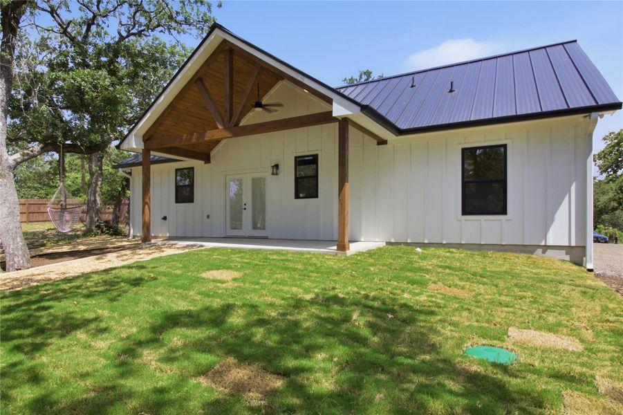 A charming backyard retreat featuring a covered patio, ample green space, and mature shade trees. A charming backyard retreat featuring a covered patio, ample green space, and mature shade trees.