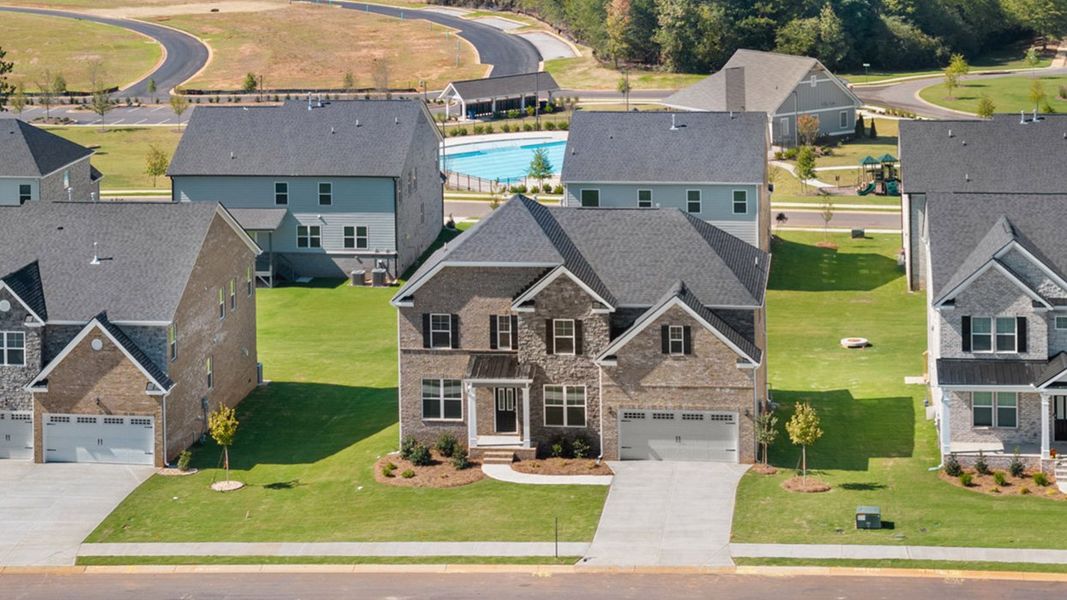 Front exterior of a new home in Heritage Pointe, Senoia, GA, highlighting curb appeal (Image 28). Front exterior of a new home in Heritage Pointe, Senoia, GA, highlighting curb appeal (Image 28).