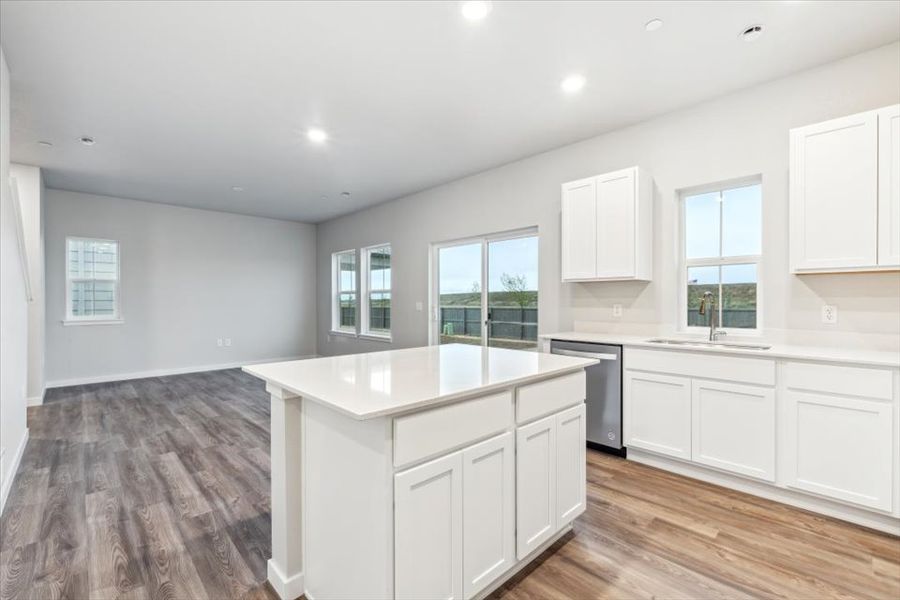A kitchen with white cabinets.