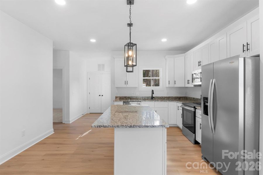 Kitchen with granite countertops, shaker cabinets and stainless steel appliances Kitchen with granite countertops, shaker cabinets and stainless steel appliances