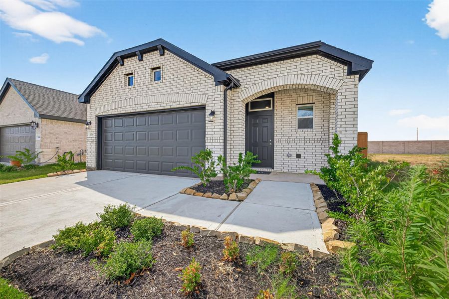 Front exterior of a new home in Sunterra, Katy, TX, highlighting curb appeal (Image 27). Front exterior of a new home in Sunterra, Katy, TX, highlighting curb appeal (Image 27).