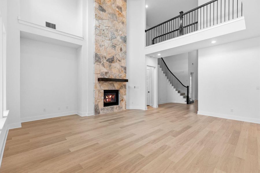 Family Room with soaring ceiling & fireplace