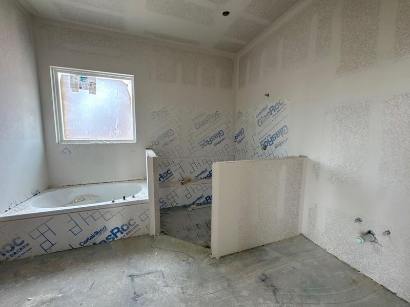 Full bathroom featuring a bath Full bathroom featuring a bath