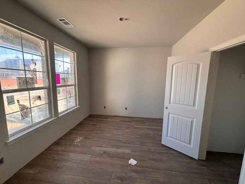 Unfurnished room with dark wood finished floors Unfurnished room with dark wood finished floors
