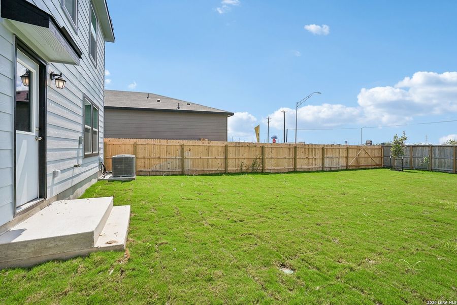 Exterior details and patio area of a home in Medina Crossing, Von Ormy (Image 18).