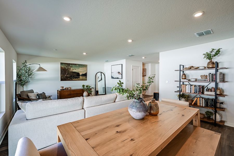 A living room with a table and a couch. A living room with a table and a couch.