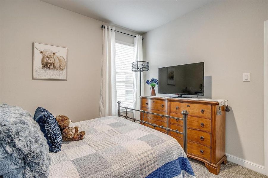 Carpeted bedroom with baseboards