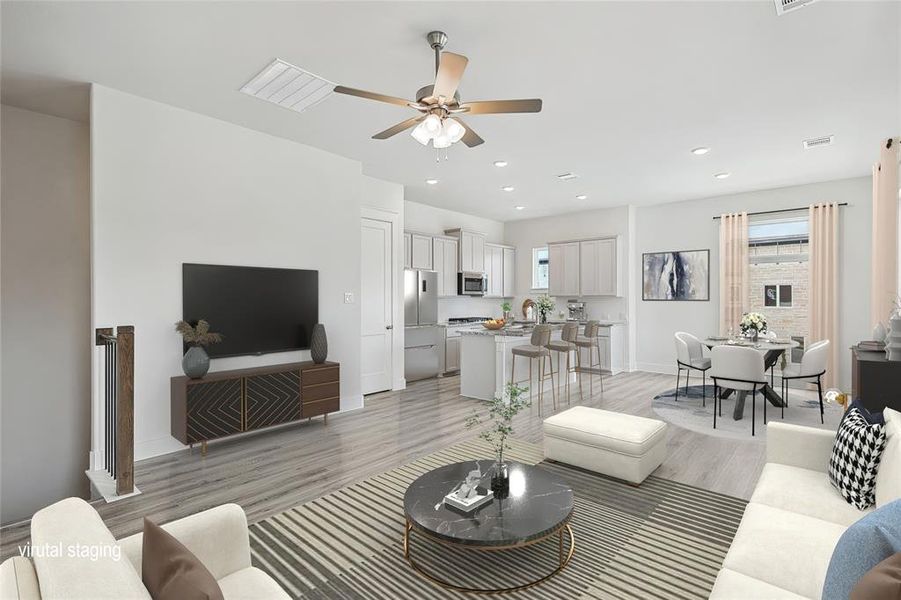 Living room with light hardwood / wood-style flooring, ceiling fan, and sink