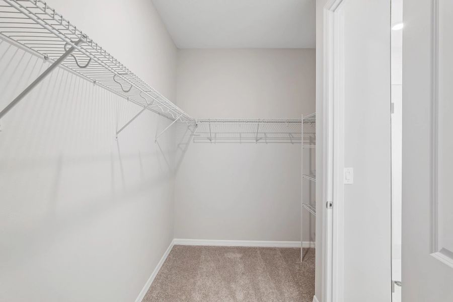 Spacious walk-in closet located off the primary bathroom