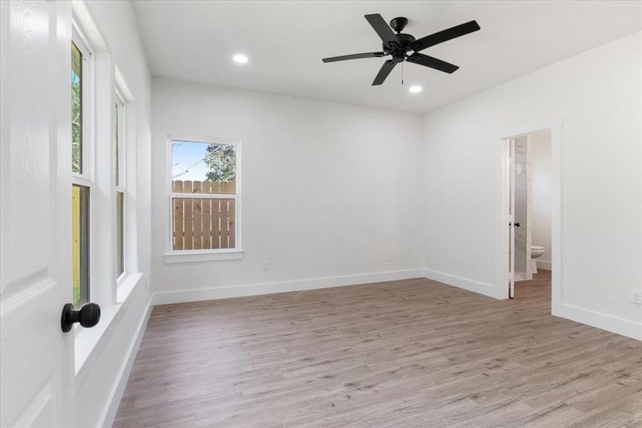 Empty room featuring ceiling fan and light wood-type flooring