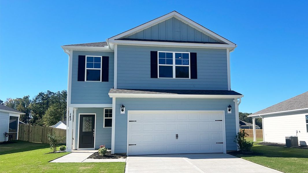 Front exterior of a new home in Sease's Pond, Gilbert, SC, highlighting curb appeal (Image 1). Front exterior of a new home in Sease's Pond, Gilbert, SC, highlighting curb appeal (Image 1).
