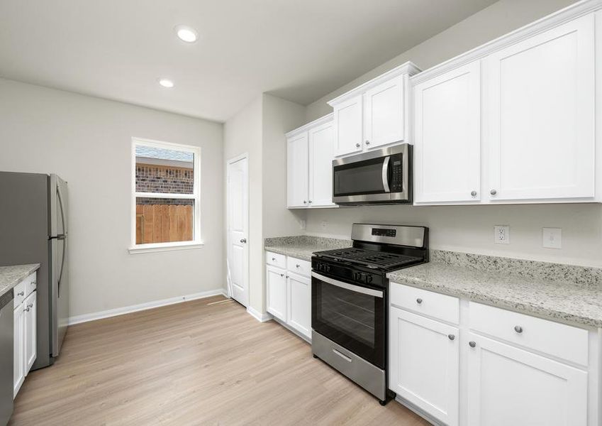 The kitchen is filled with stainless steel appliances