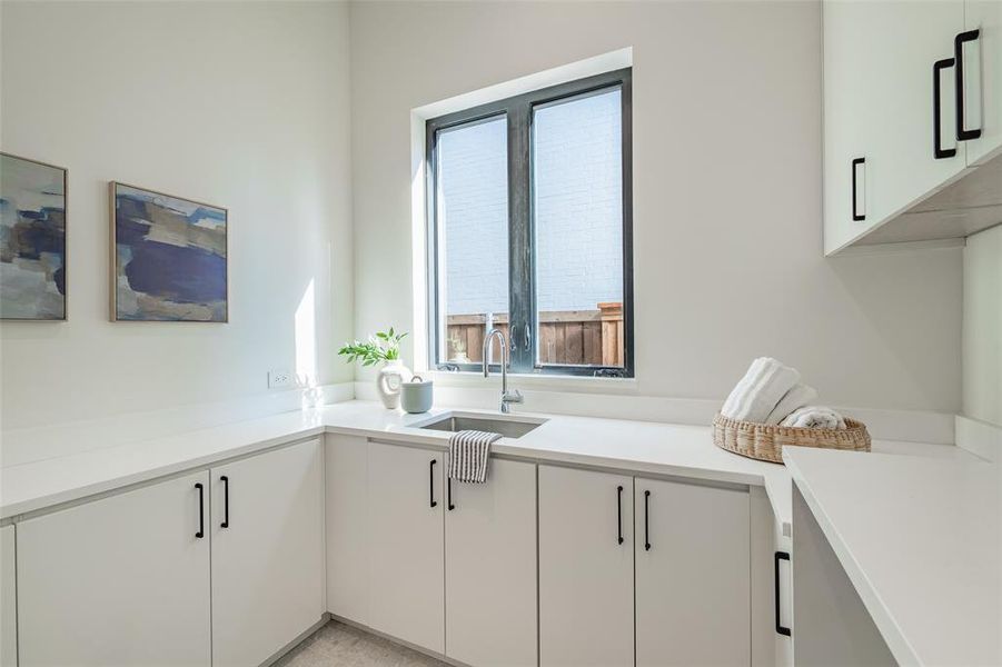 Kitchen with sink and white cabinets