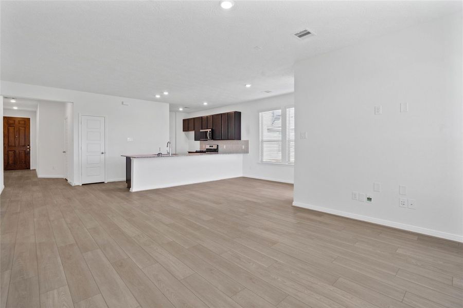 Beautiful open-concept layout effortlessly uniting the living, dining, and kitchen spaces—ideal for everyday comfort and entertaining guests!