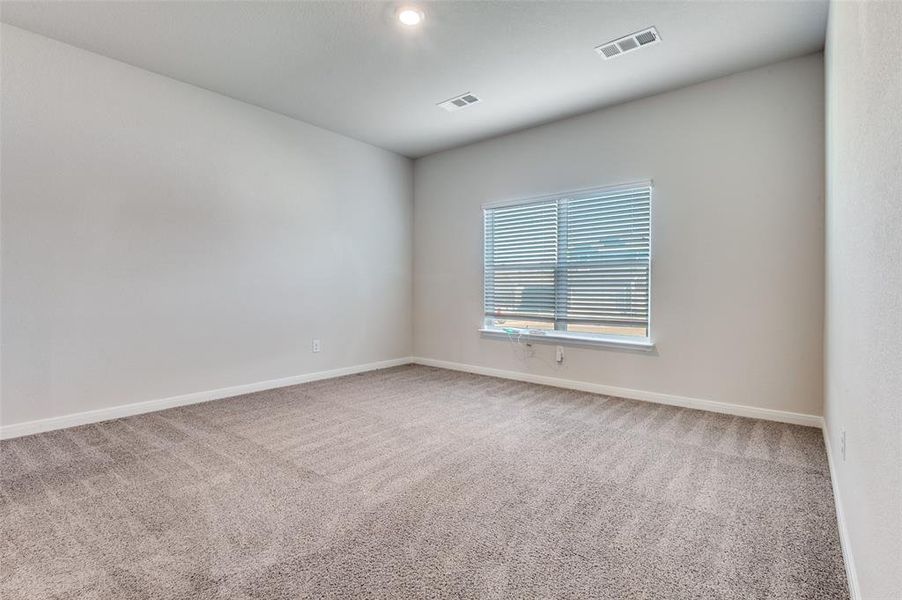 Spare room with light colored carpet and baseboards