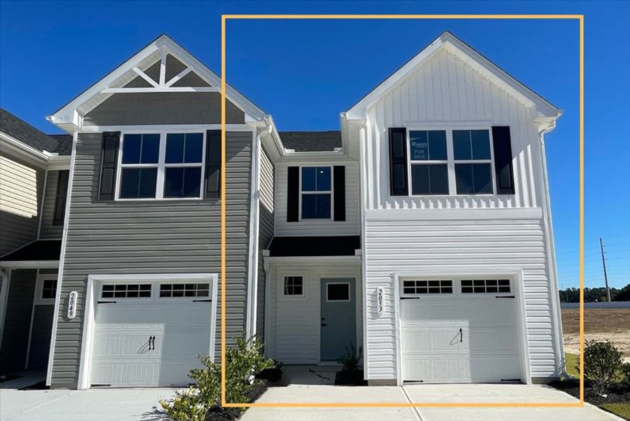 Front exterior of a new home in Bell Creek Townhomes, Winnabow, NC, highlighting curb appeal (Image 1).