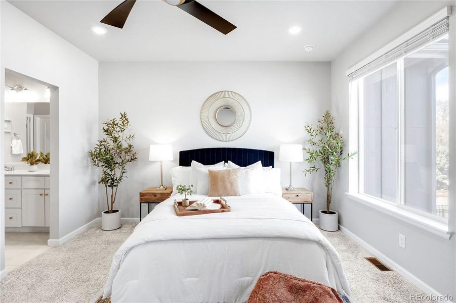 The upper level features three bedrooms, including this bedroom, the primary suite.