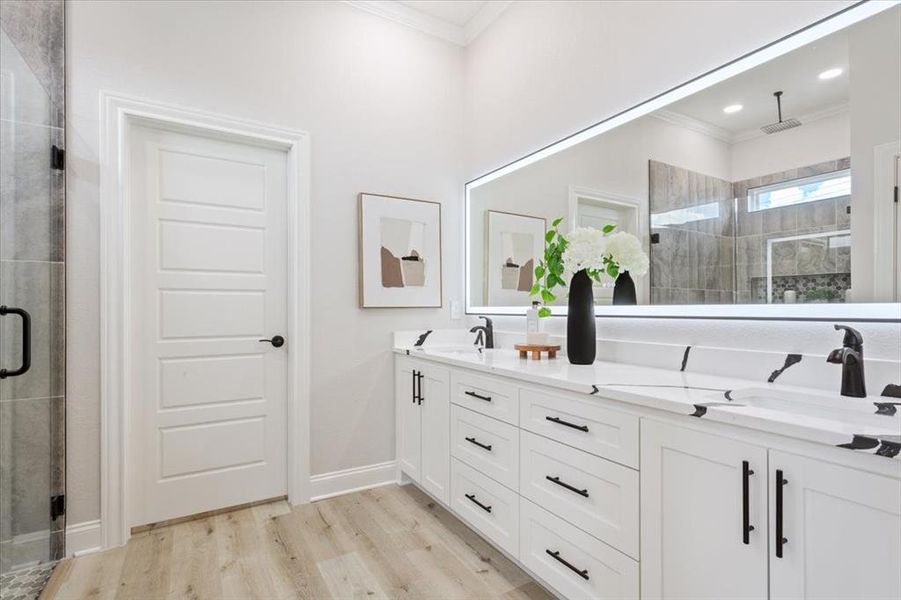 Primary bath with double vanity, a shower stall, touch screen LED mirror, & walk in closet. Primary bath with double vanity, a shower stall, touch screen LED mirror, & walk in closet.