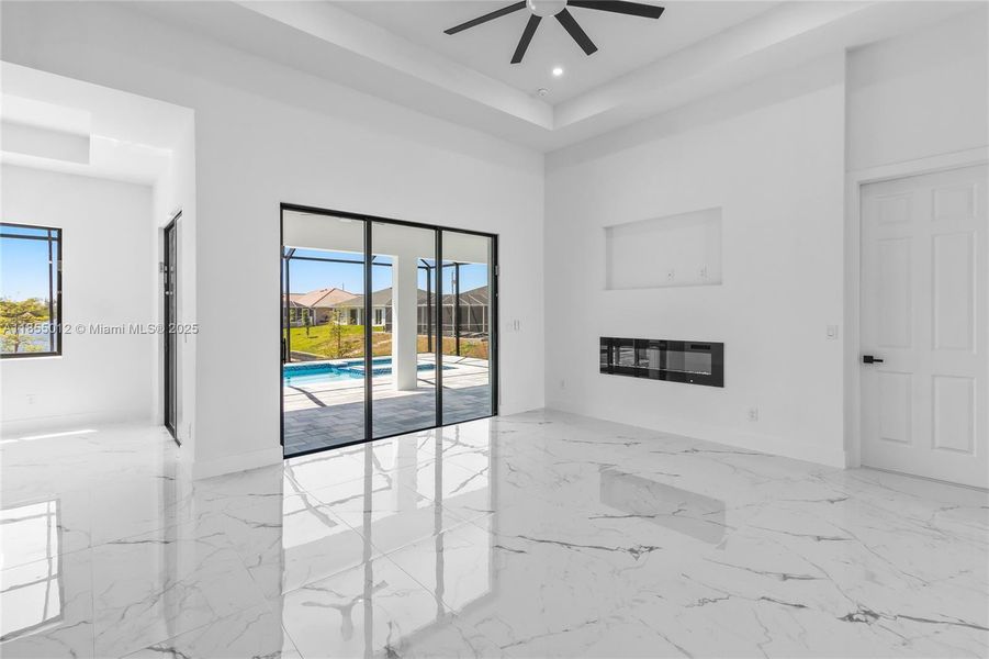 Living Room Boasts beautiful fireplace, tray ceiling with recessed lights