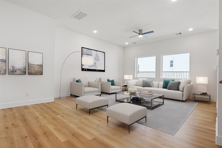 Ascending to the second floor, you'll find an open concept living area featuring the spacious living room, modern kitchen, and conveniently located half bath.