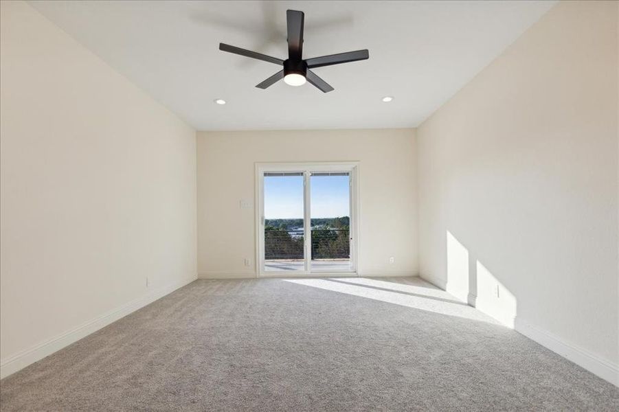 Spare room with ceiling fan and carpet floors