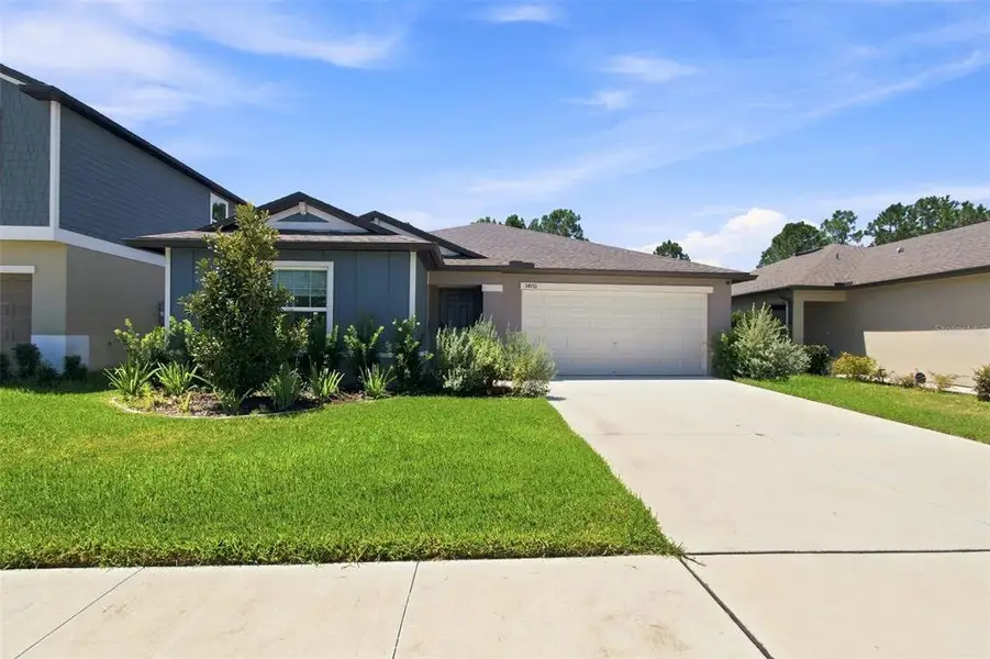 Front exterior of a new home in , Zephyrhills, FL, highlighting curb appeal (Image 2). Front exterior of a new home in , Zephyrhills, FL, highlighting curb appeal (Image 2).