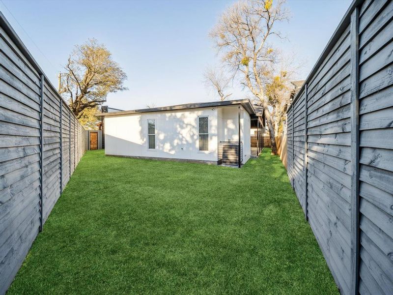 Back of house featuring a lawn