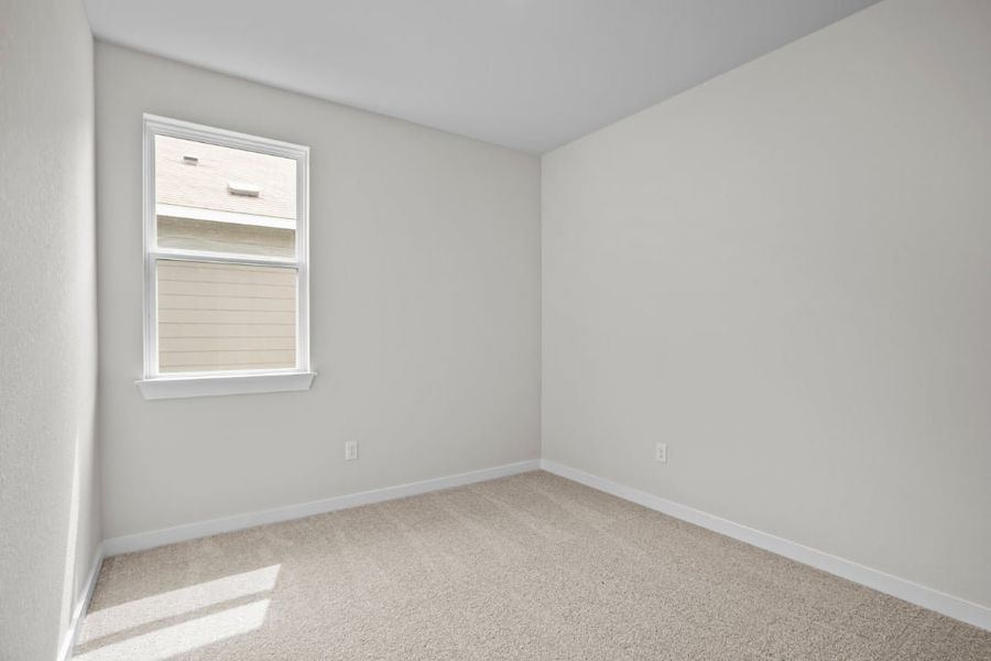 A room with a window and carpet.