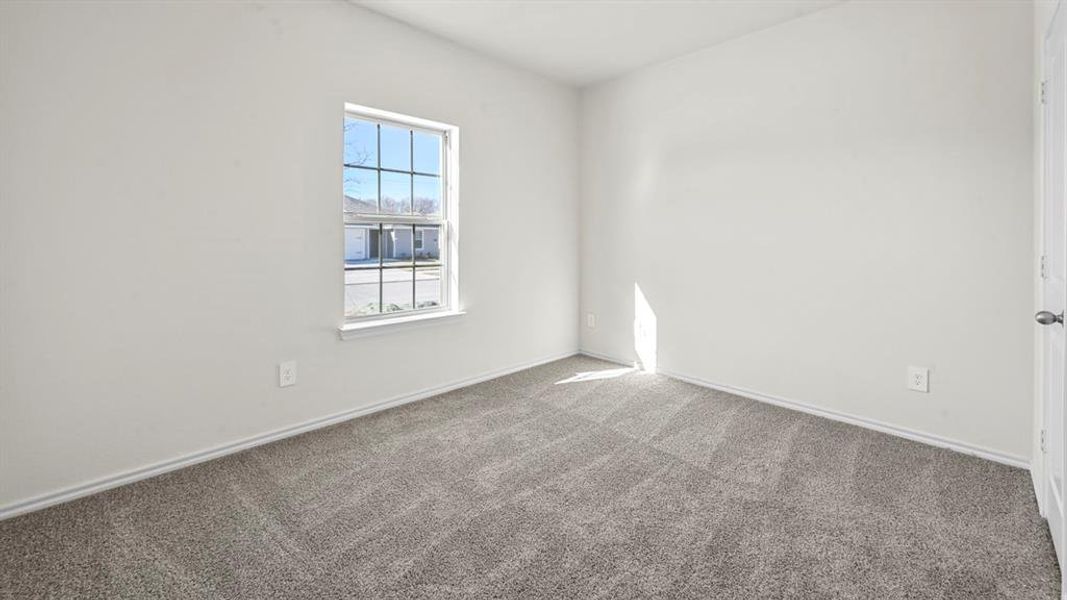 Neutral white walls complement the gray patterned carpet