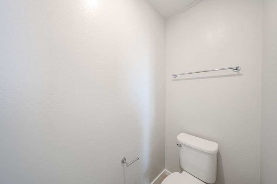 A toilet in a bathroom.