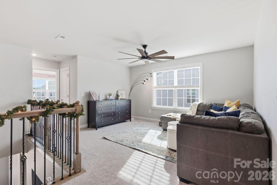 Upstairs offers plenty of room to roam and relax, with a spacious loft at the top of the stairs...