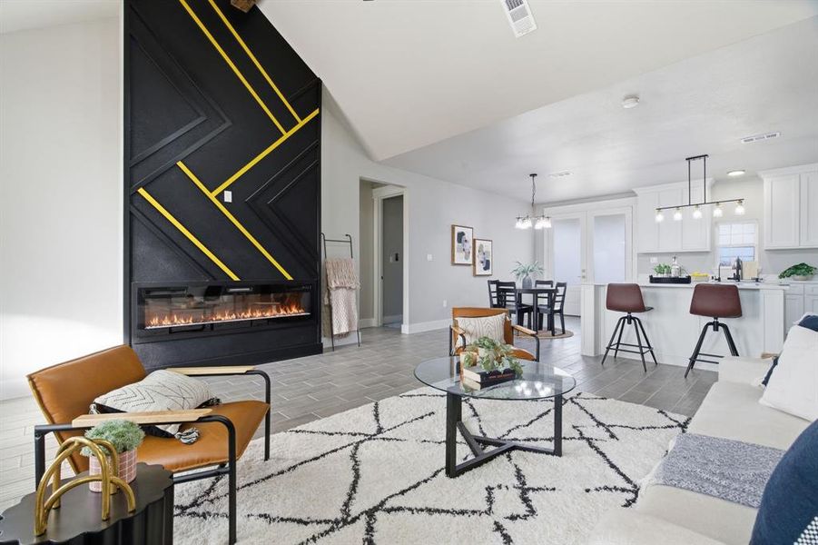 Living room with a glass covered fireplace and wood tiled floors