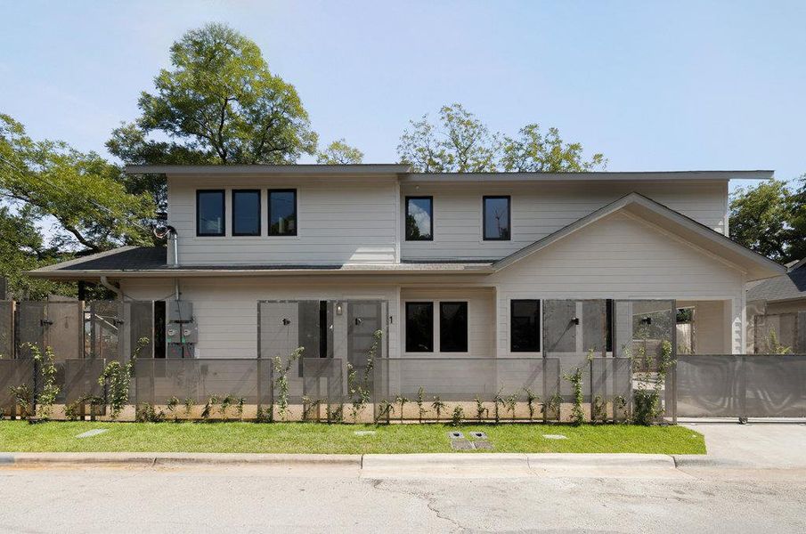 View of front of property with a fenced front yard and a sunroom View of front of property with a fenced front yard and a sunroom