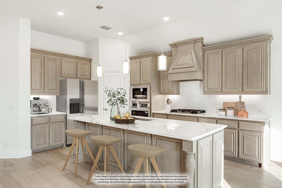 Kitchen with tan raised-panel cabinets, marble island with three stools, and stainless steel appliances