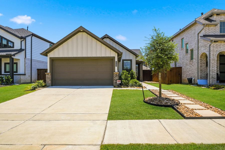 Front exterior of a new home in Meridiana 40', 65', Iowa Colony, TX, highlighting curb appeal (Image 2).