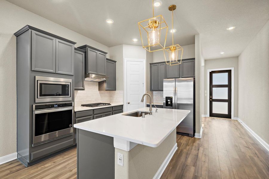 Outfitted with stainless steel appliances, including a gas range, double-door refrigerator and Oven this kitchen combines style and efficiency. Outfitted with stainless steel appliances, including a gas range, double-door refrigerator and Oven this kitchen combines style and efficiency.