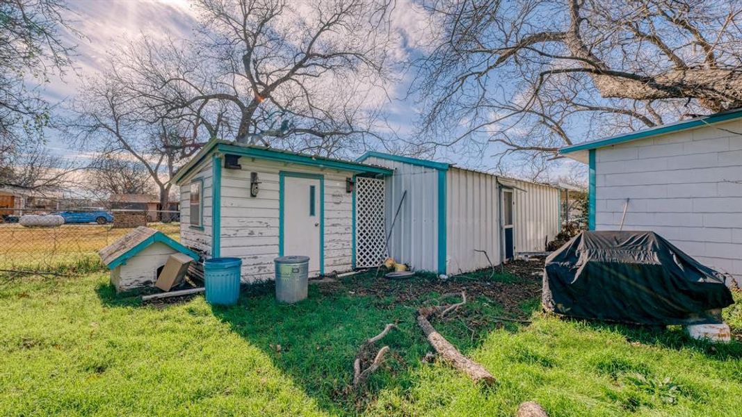 View of outdoor structure with a yard