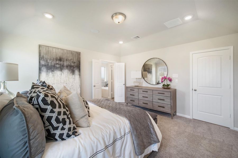 Retreat to the luxurious primary suite, your perfect escape for unwinding after a long day! Sample photo of completed home with similar floor plan. Actual colors and selections may vary.