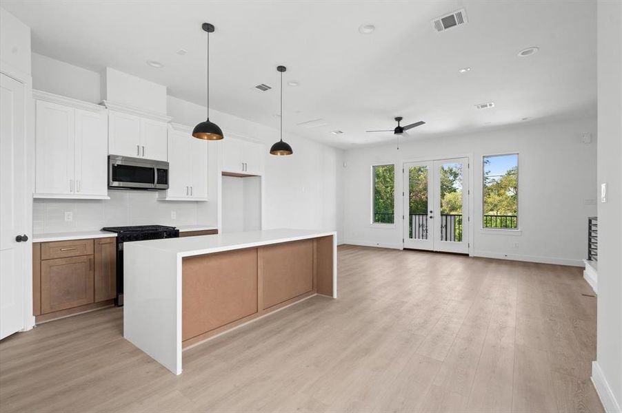 Contemporary, open-concept kitchen that flows into the living space.