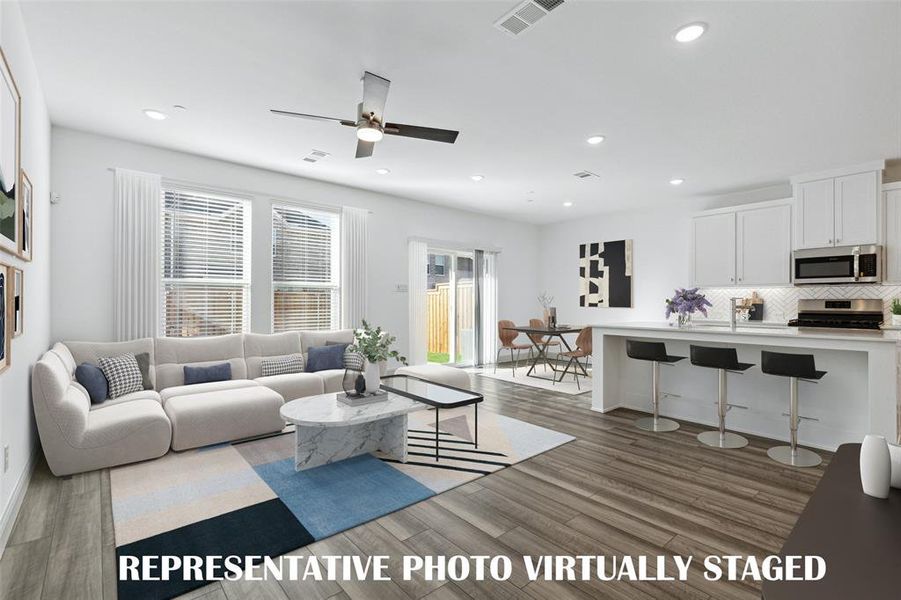 Light, bright and airy, this open concept kitchen-dining-living area is everything you have been searching for!  REPRESENTATIVE PHOTO VIRTUALLY STAGED