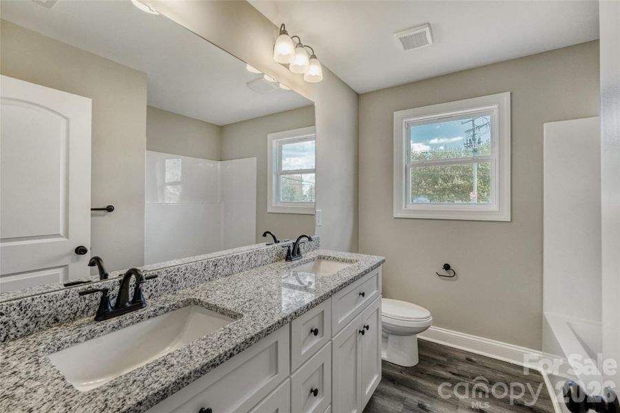 Granite countertops with dual vanities in the primary bath Granite countertops with dual vanities in the primary bath