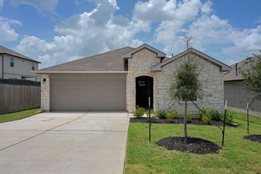 Front exterior of a new home in Carillon, Manor, TX, highlighting curb appeal (Image 1). Front exterior of a new home in Carillon, Manor, TX, highlighting curb appeal (Image 1).