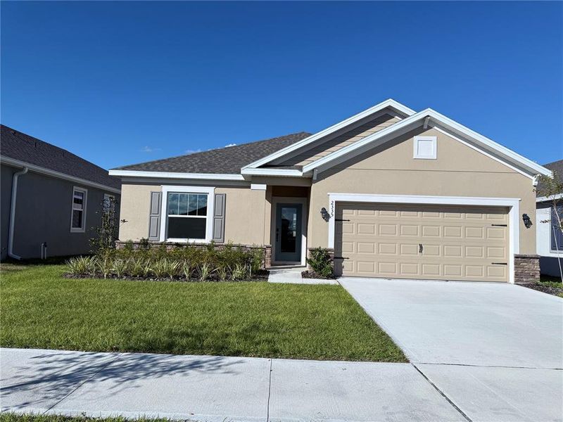 Front exterior of a new home in Eden Hills, Lake Alfred, FL, highlighting curb appeal (Image 2).