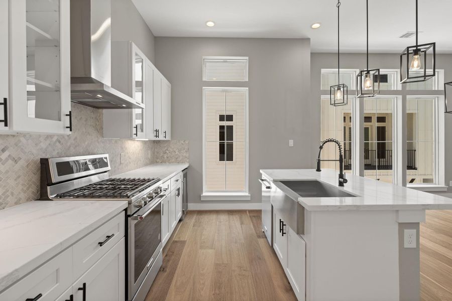 Stainless steel appliances with lovely herringbone backsplash.