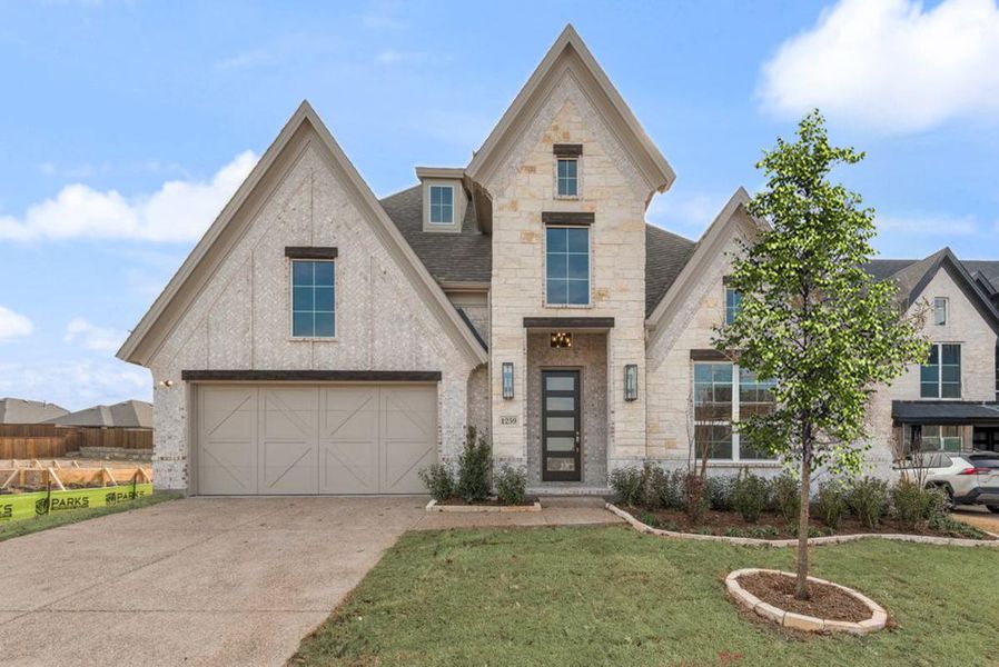 Front exterior of a new home in Monterra, Fate, TX, highlighting curb appeal (Image 1). Front exterior of a new home in Monterra, Fate, TX, highlighting curb appeal (Image 1).